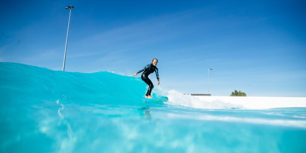 Guests surfing the wave pool at The Point Surf Park in Fellsmere, Florida
