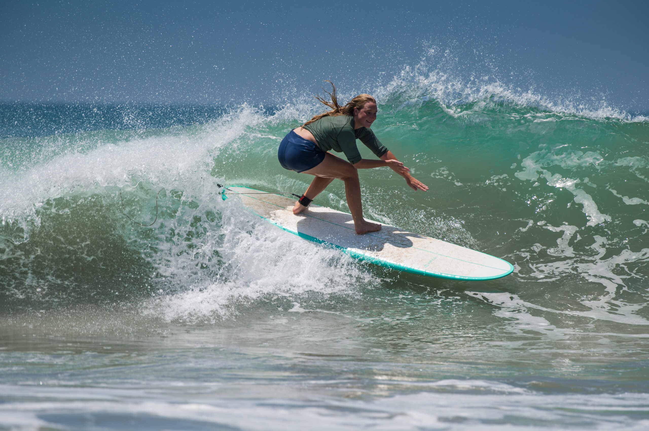 Surfer riding a perfect, machine-shaped wave at The Point Surf Park in Fellsmere, Florida