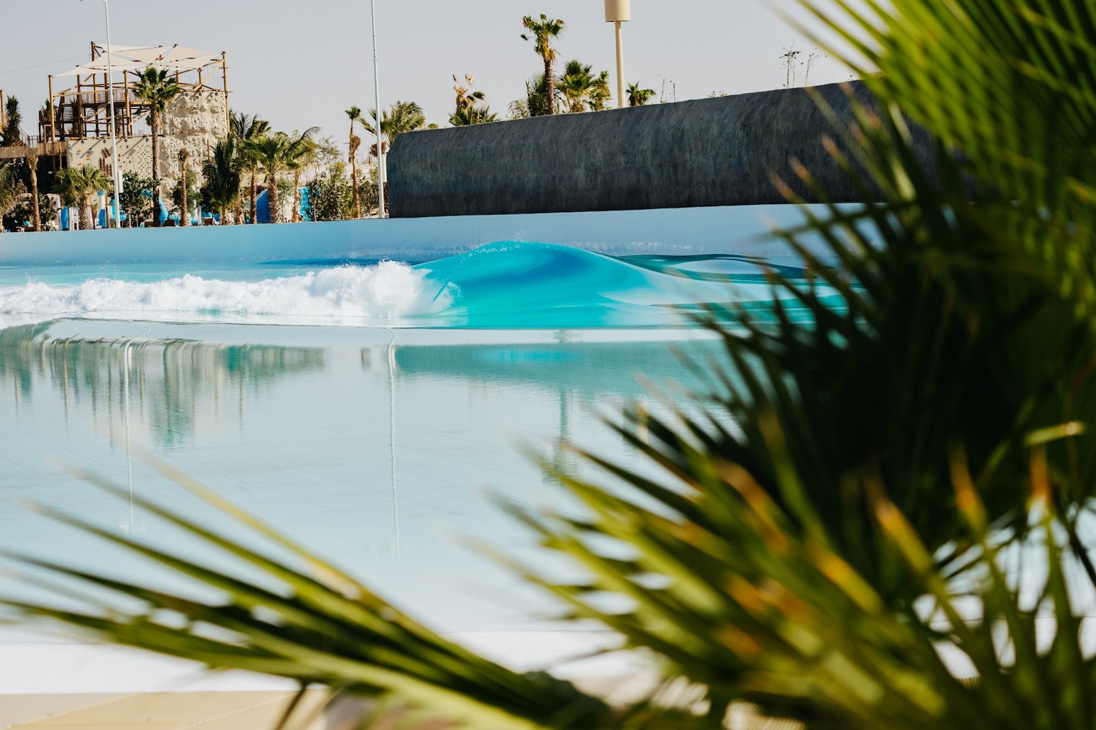 Surfer riding a perfect, machine-shaped wave at The Point Surf Park in Fellsmere, Florida
