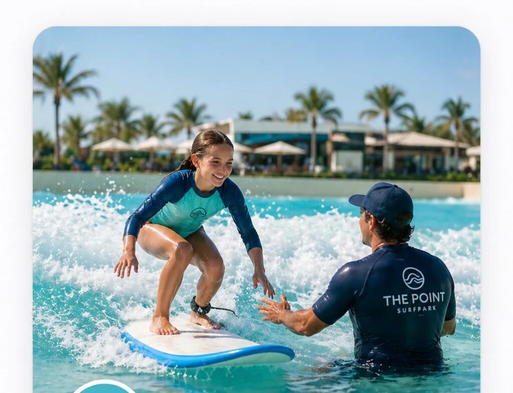 Beginner surfer on a soft-top board during a coached session at The Point Surf Park in Fellsmere, Florida
